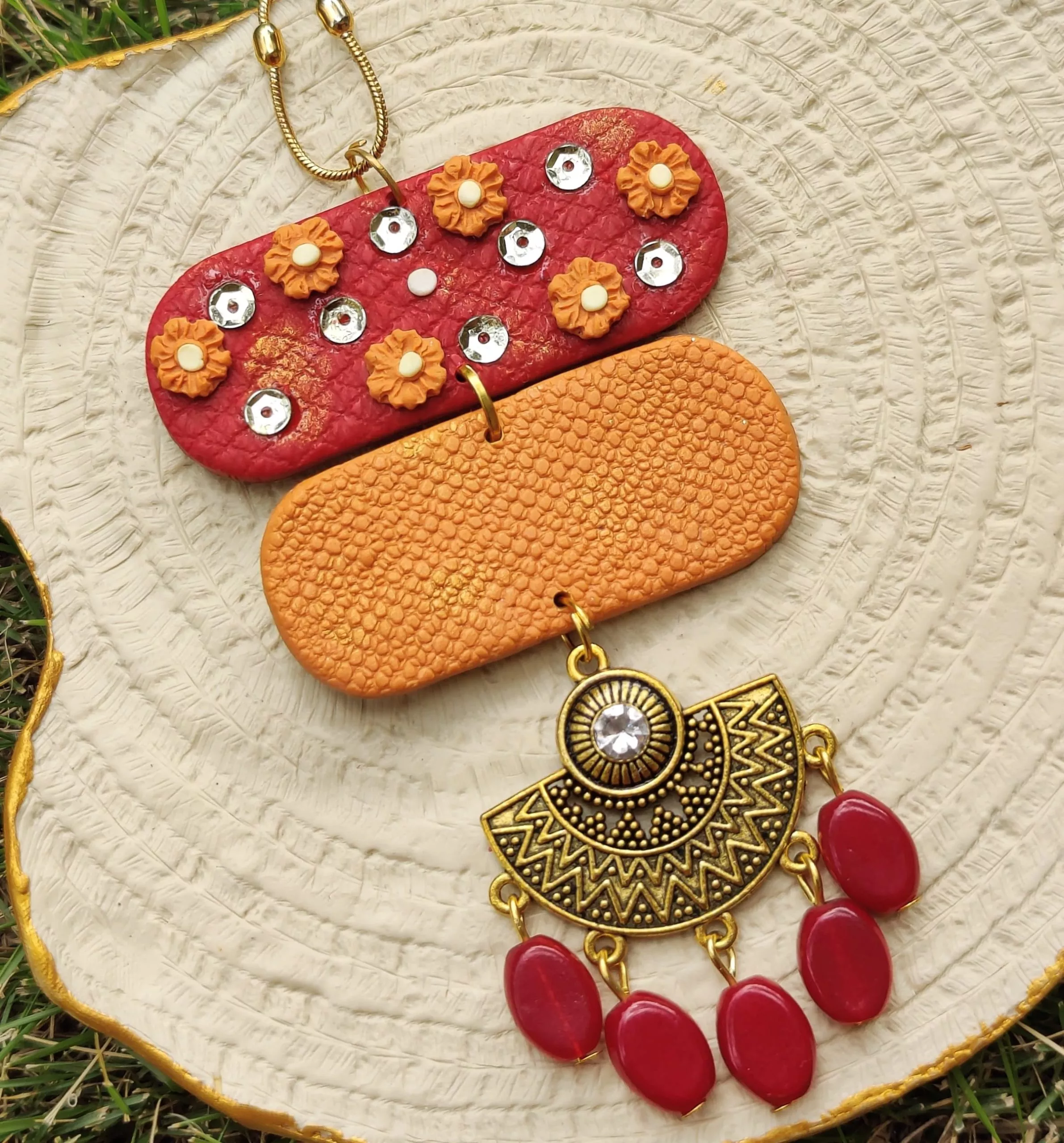 Handmade ethnic necklace for a sparkling and unique touch. And with mind-blowing striking red and orange color, be ready to enchant your friends and foes with out royal necklace. Made with trendy beads and polymer clay, flaunt charm pendant, a magical blend of eastern and western, with any shaadi attire.
