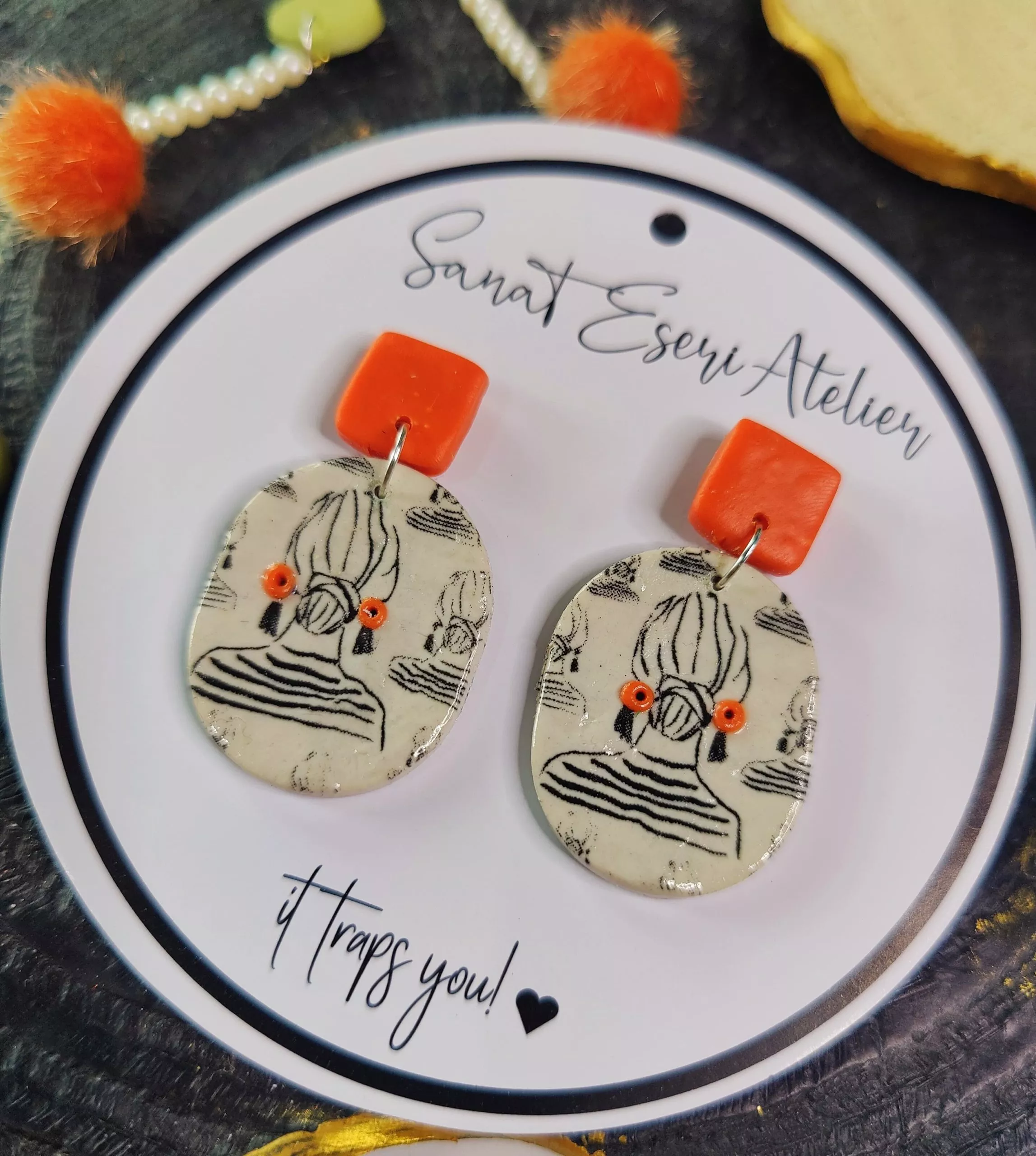 Oval Shaped Imprinted Girl with a Bun Earrings in Orange and White