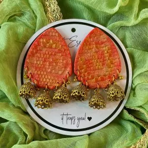 This is our big statement earrings that are beautifully handcrafted with a vibrant and textured orange-red teardrop-shaped base.