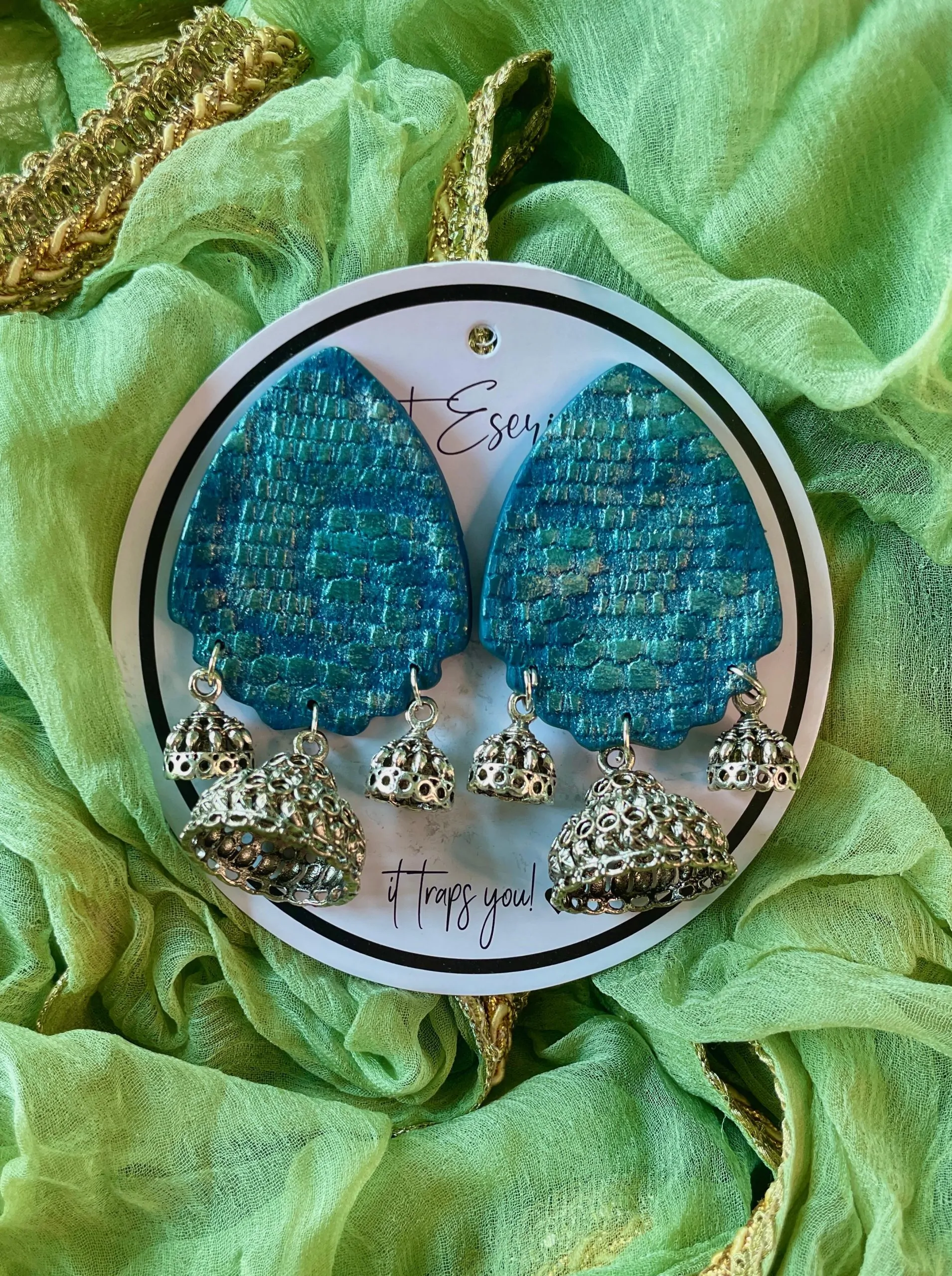 This is our big statement earrings that are beautifully handcrafted with a vibrant and textured orange-red teardrop-shaped base.