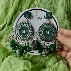 These are our green Chandbali earrings. Designed with intricate silver work, small jhumkas, and green beads, these earrings are perfect for weddings, parties, and festive occasions. The lightweight yet statement design makes them comfortable to wear all day. Pair them with ethnic outfits like sarees, lehengas, or kurtis for a complete look.