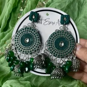 These are our green Chandbali earrings. Designed with intricate silver work, small jhumkas, and green beads, these earrings are perfect for weddings, parties, and festive occasions. The lightweight yet statement design makes them comfortable to wear all day. Pair them with ethnic outfits like sarees, lehengas, or kurtis for a complete look.