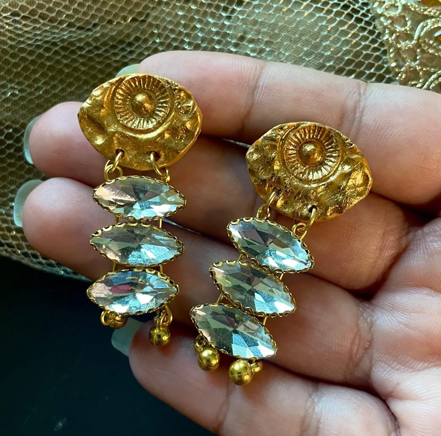 Gold-plated crescent moon polymer clay earrings with textured details and crystals, inspired by Mughal and Persian designs. Great for weddings and festive looks.