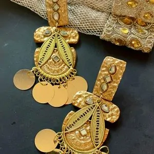 A pair of long gold dangle earrings with polymer clay, hammered metal, mirror stones, and gold coin charms, perfect for wedding and festive jewelry looks.