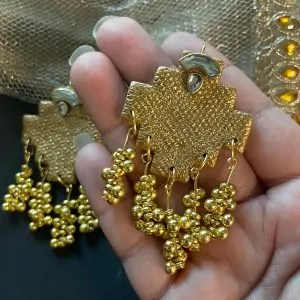 Handmade gold-textured earrings with geometric shape and beaded tassels, perfect for cultural and festive outfits.