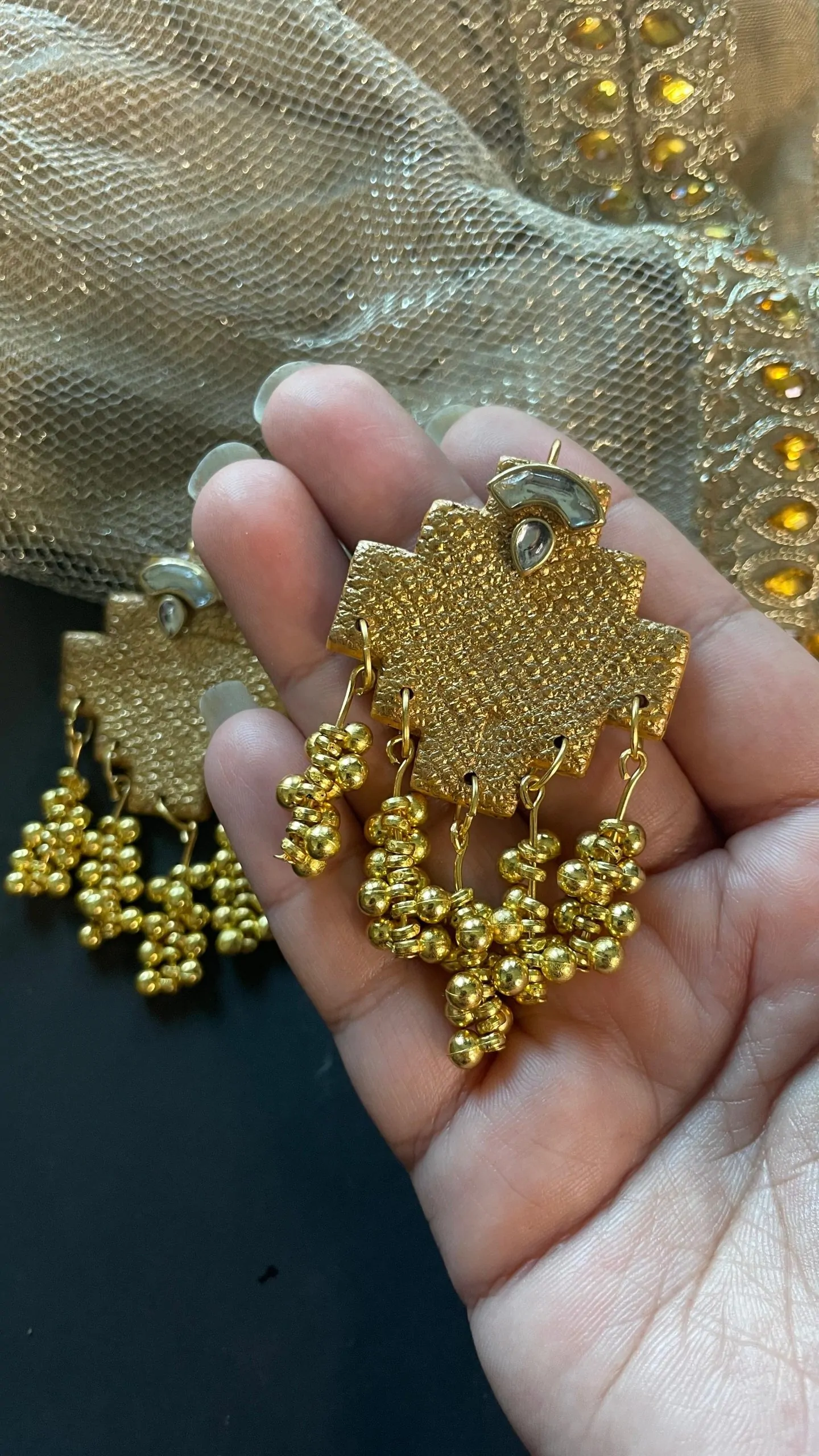 Regal Gold Drop Earrings with Beaded Tassels Handmade gold-textured earrings with geometric shape and beaded tassels, perfect for cultural and festive outfits.