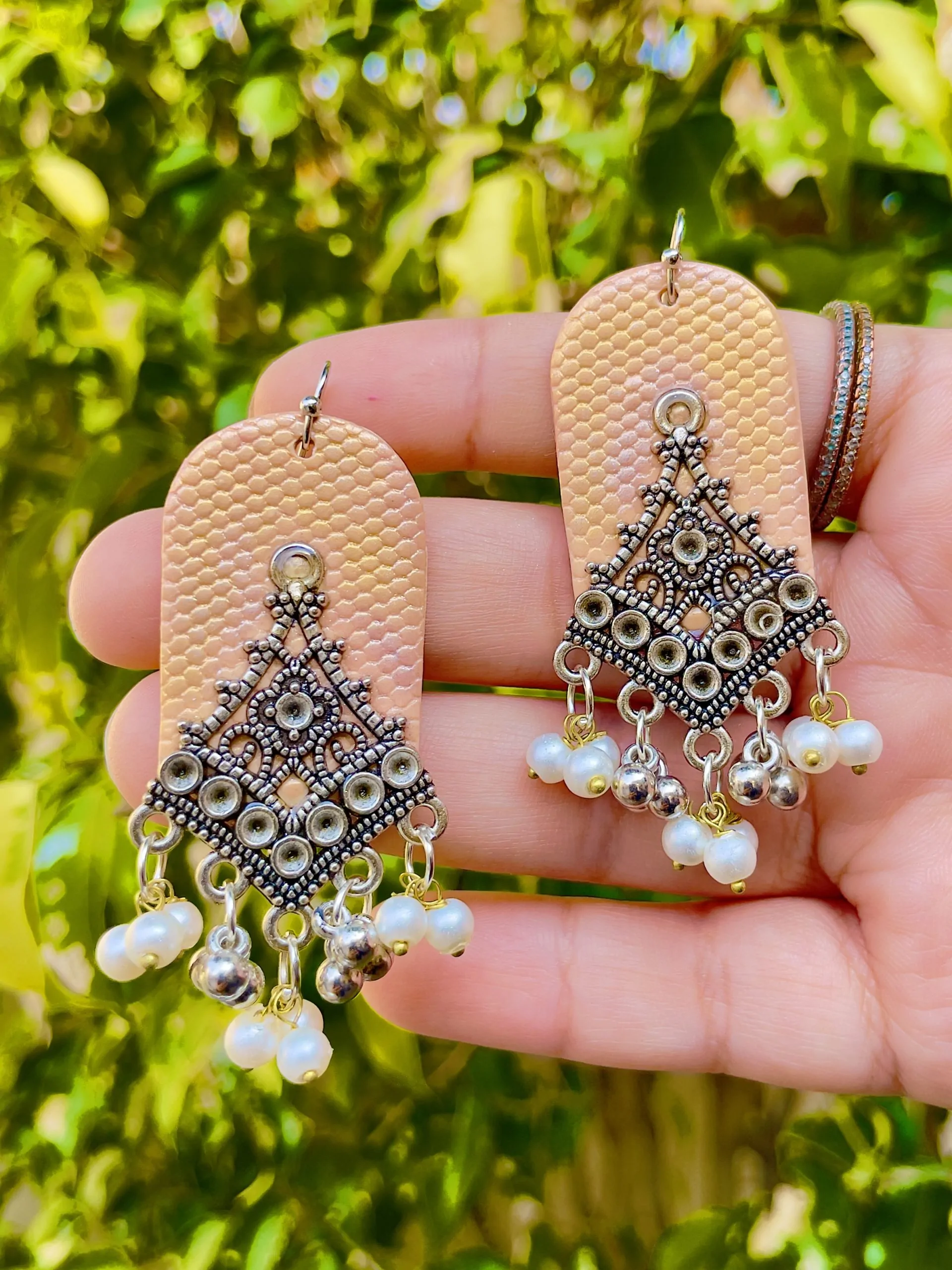 Handmade ethnic fusion statement earrings in peach and antique silver finish for festival fashion.