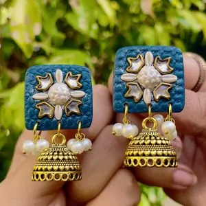Deep teal square textured earrings with silver-toned floral work and Jhumka bell drops.