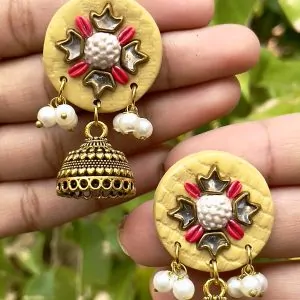 Butter yellow round textured earrings with gold Jhumka bells.