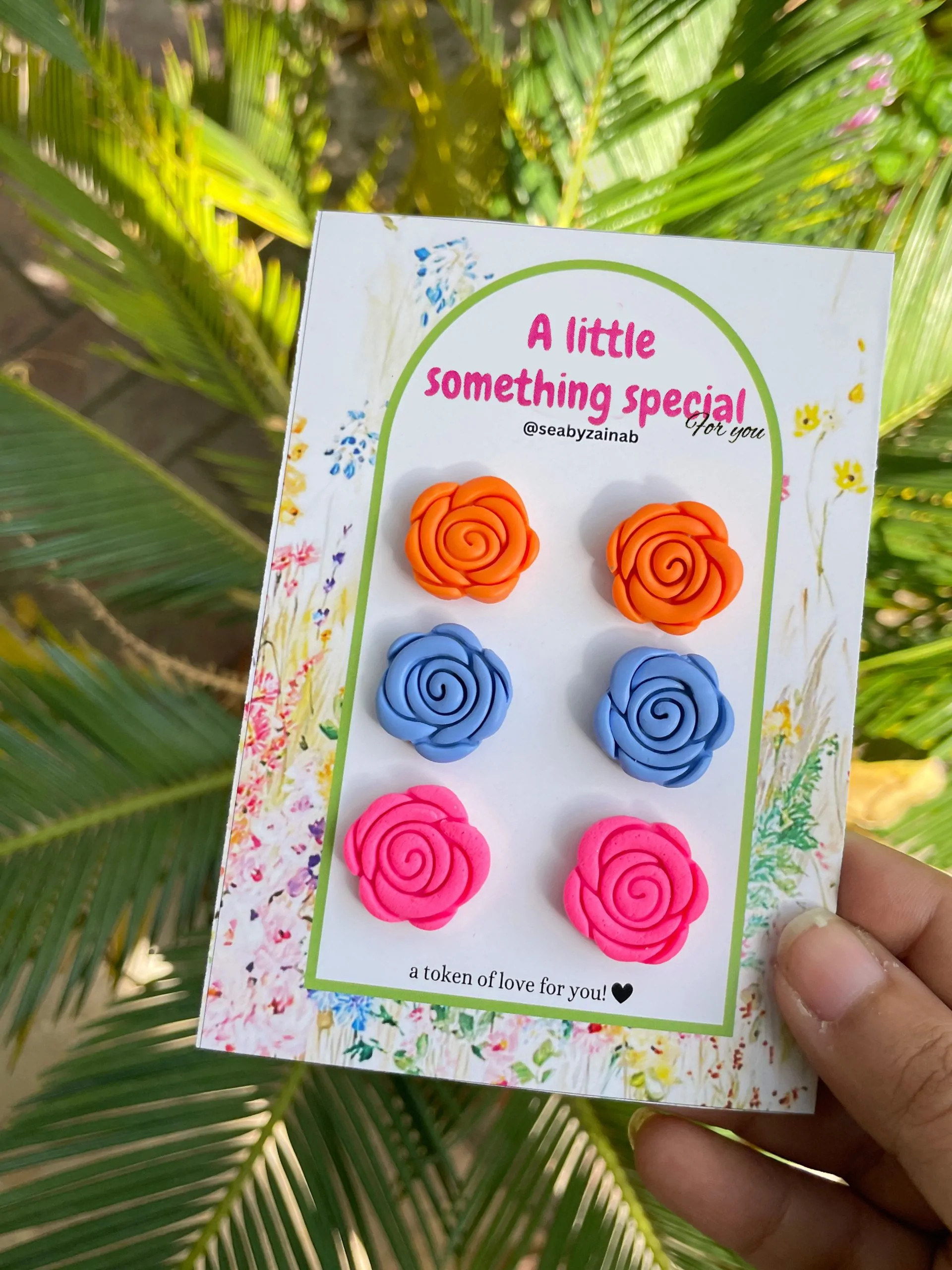 Teal, coral, and neon pink rose stud earring trio.