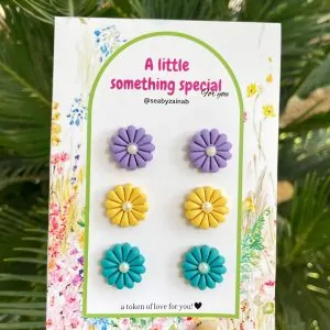 Three pairs of flower stud earrings in lilac, yellow, ferozi
