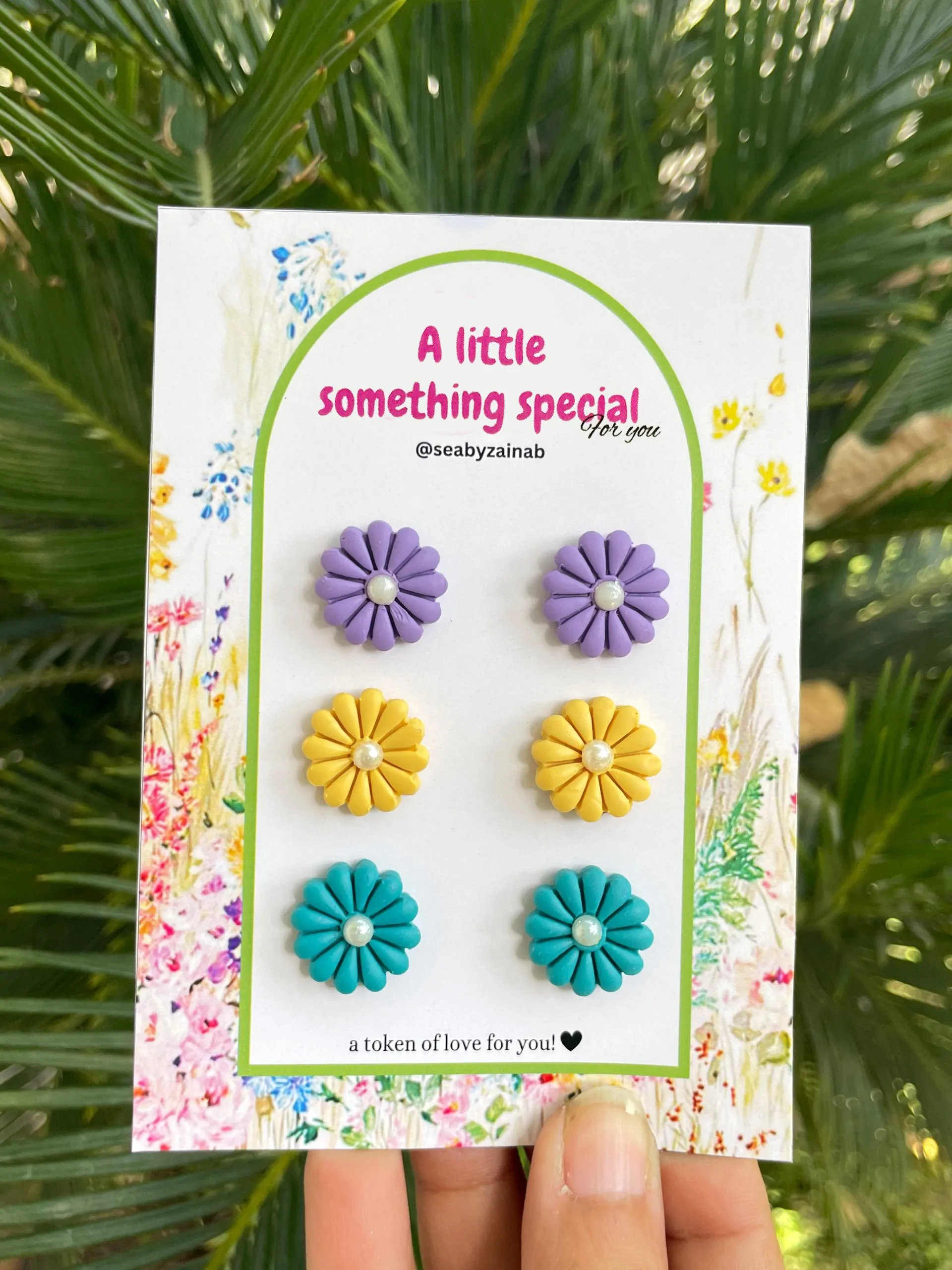 Three pairs of flower stud earrings in lilac, yellow, ferozi