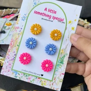 Yellow, blue, and pink 3-pair floral earring pack on gift card.
