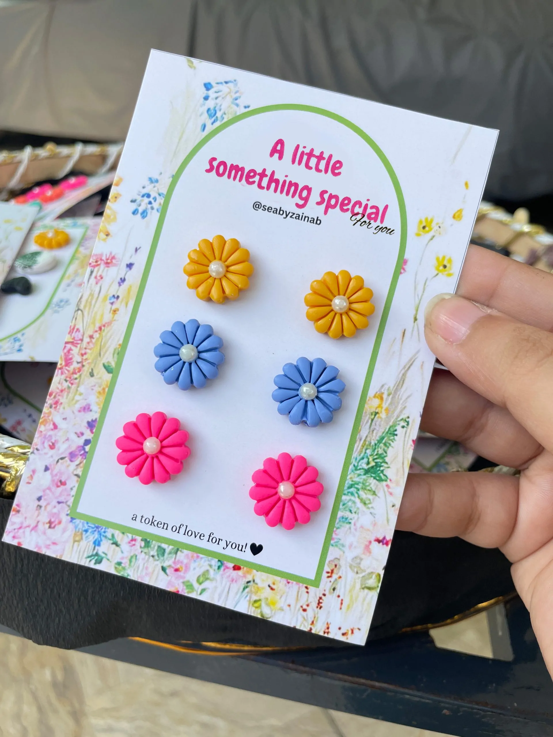 Yellow, blue, and pink 3-pair floral earring pack on gift card.