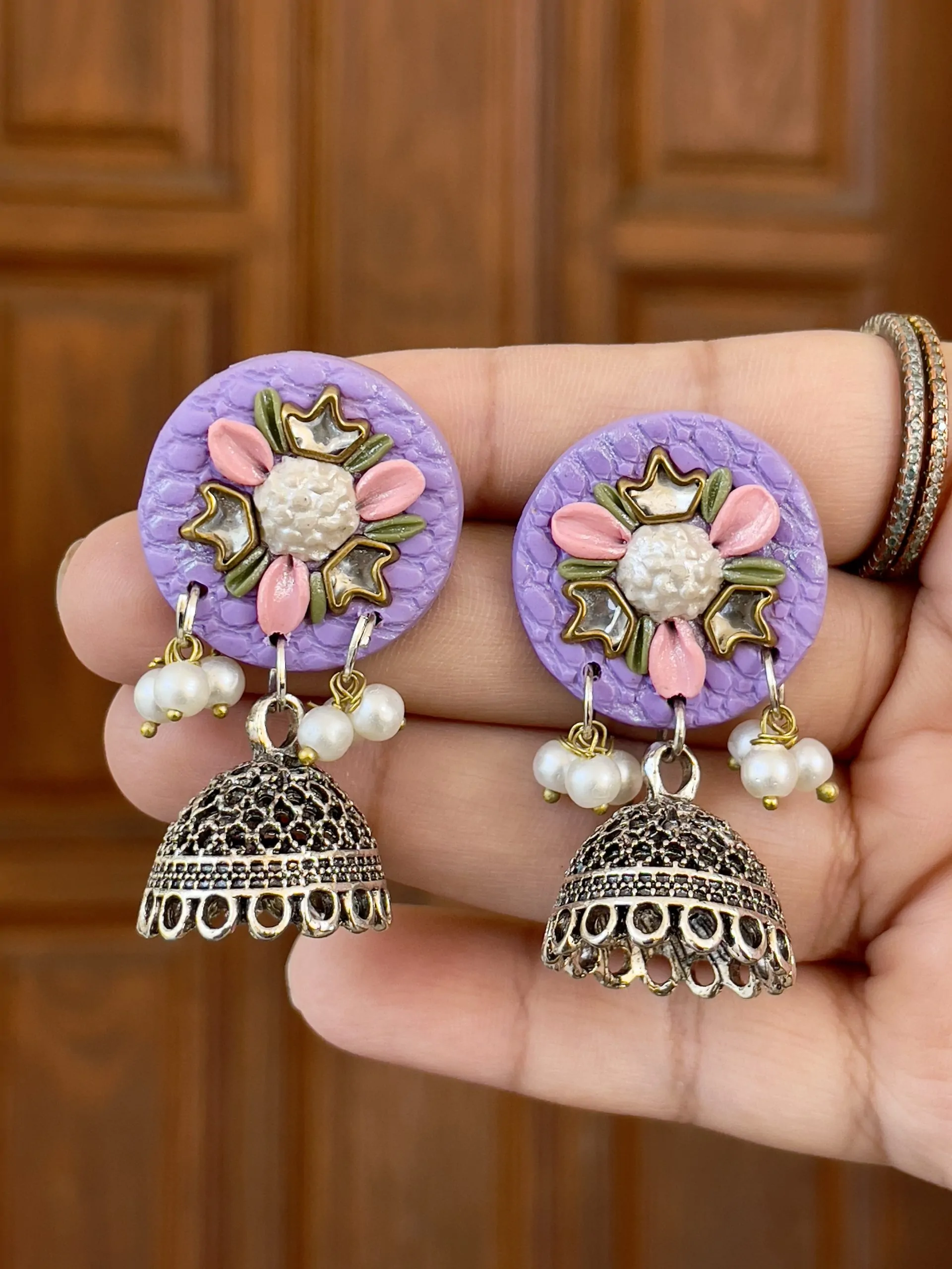 Lavender purple circular earrings with silver mirror work and Jhumka drops.