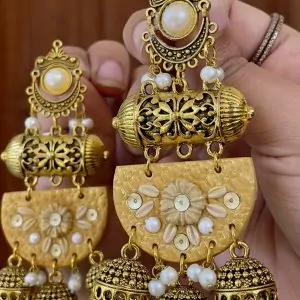 Ochre yellow textured chandelier earrings with cream floral details and gold metalwork.