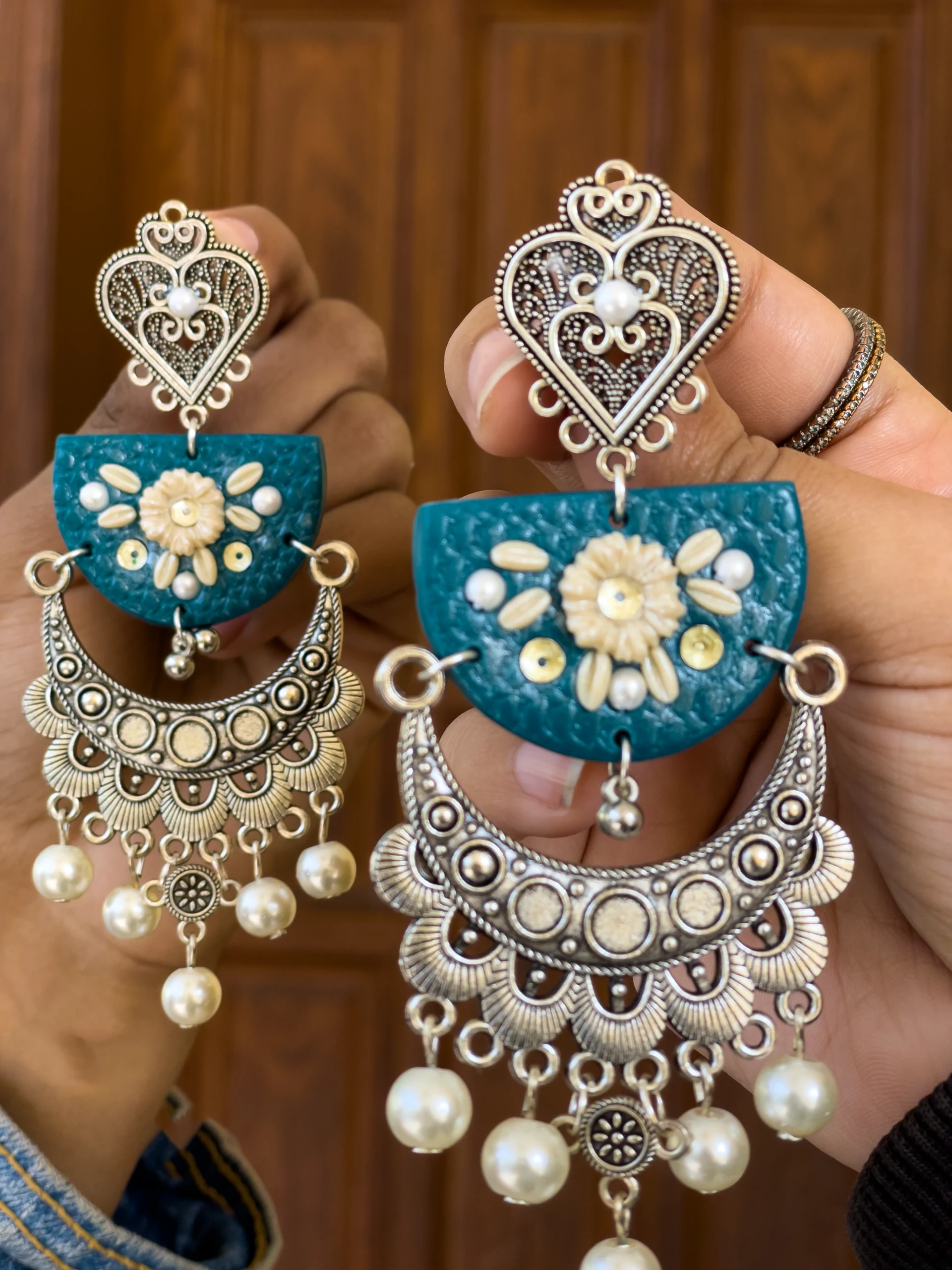 Handmade teal and silver crescent moon chandelier earrings with white pearl dangles and floral accents